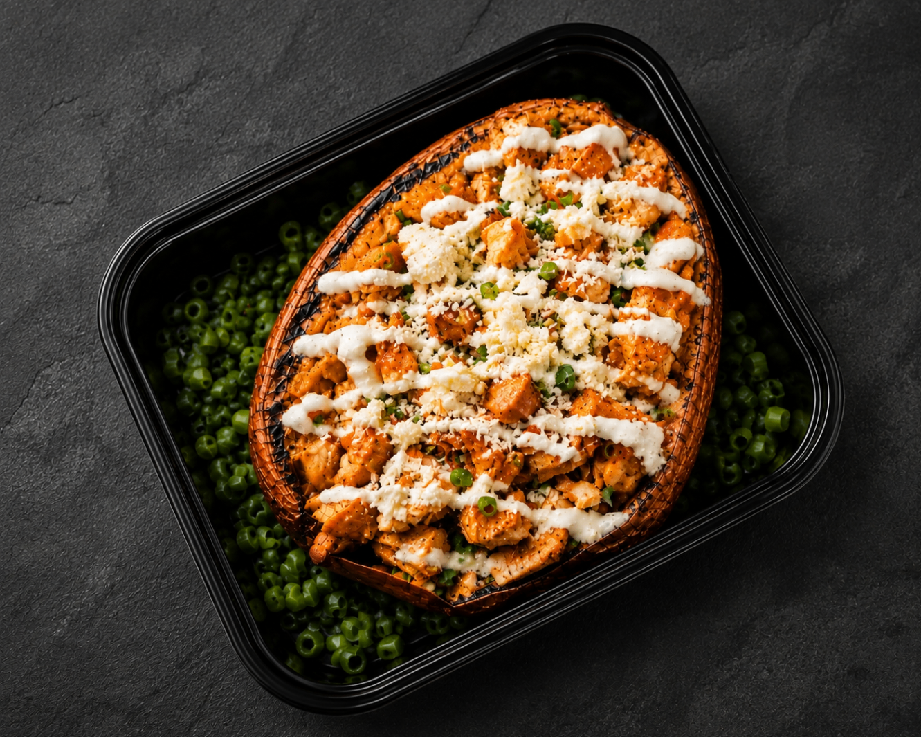 Buffalo chicken loaded sweet potato with cheese and green onions