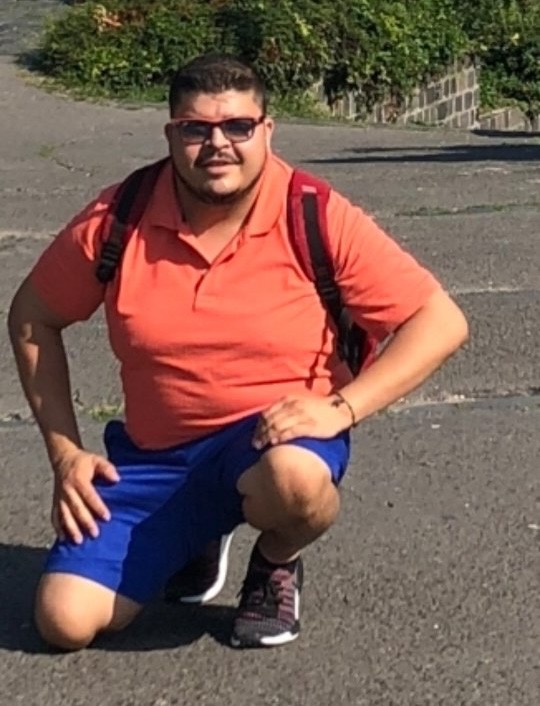 The founder before his health transformation, wearing an orange polo shirt