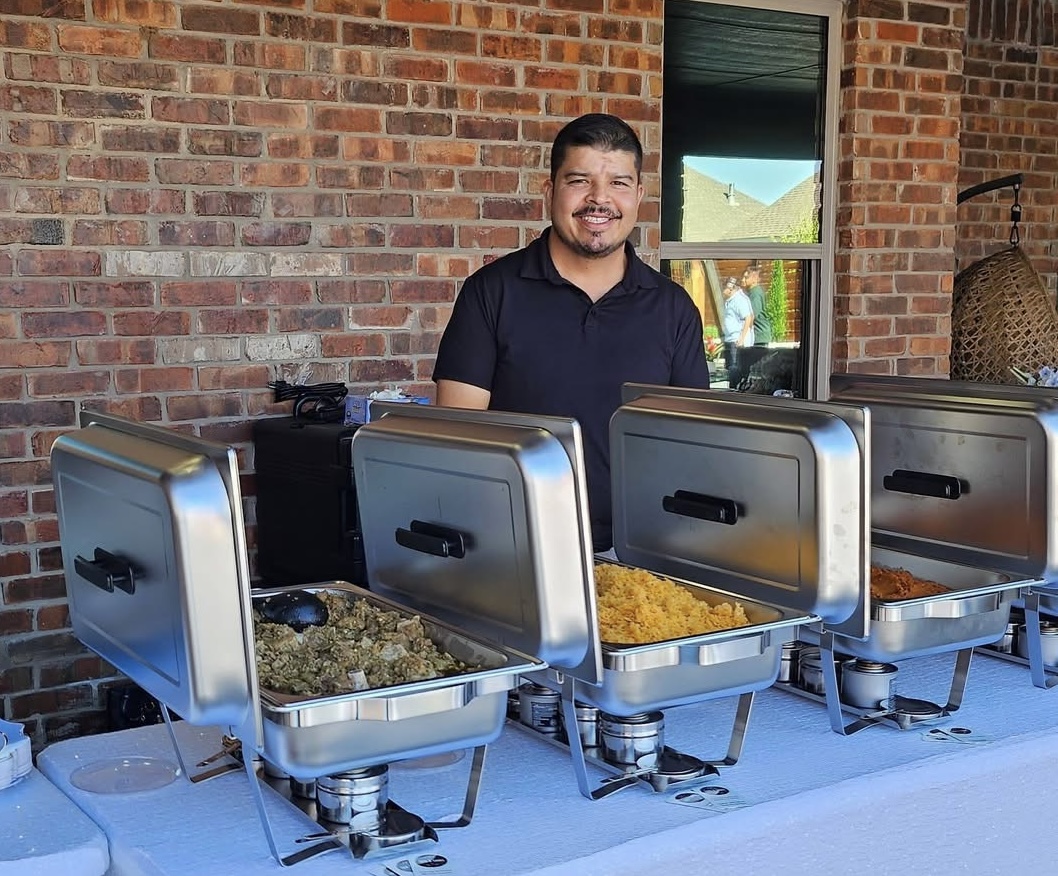 The founder behind a catered buffet setup with stainless steel chafing dishes