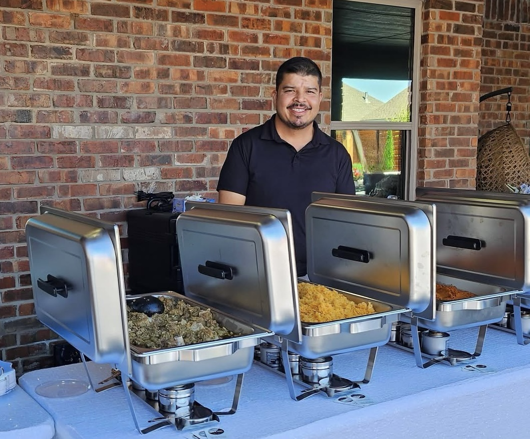 The founder behind a catered buffet setup with stainless steel chafing dishes
