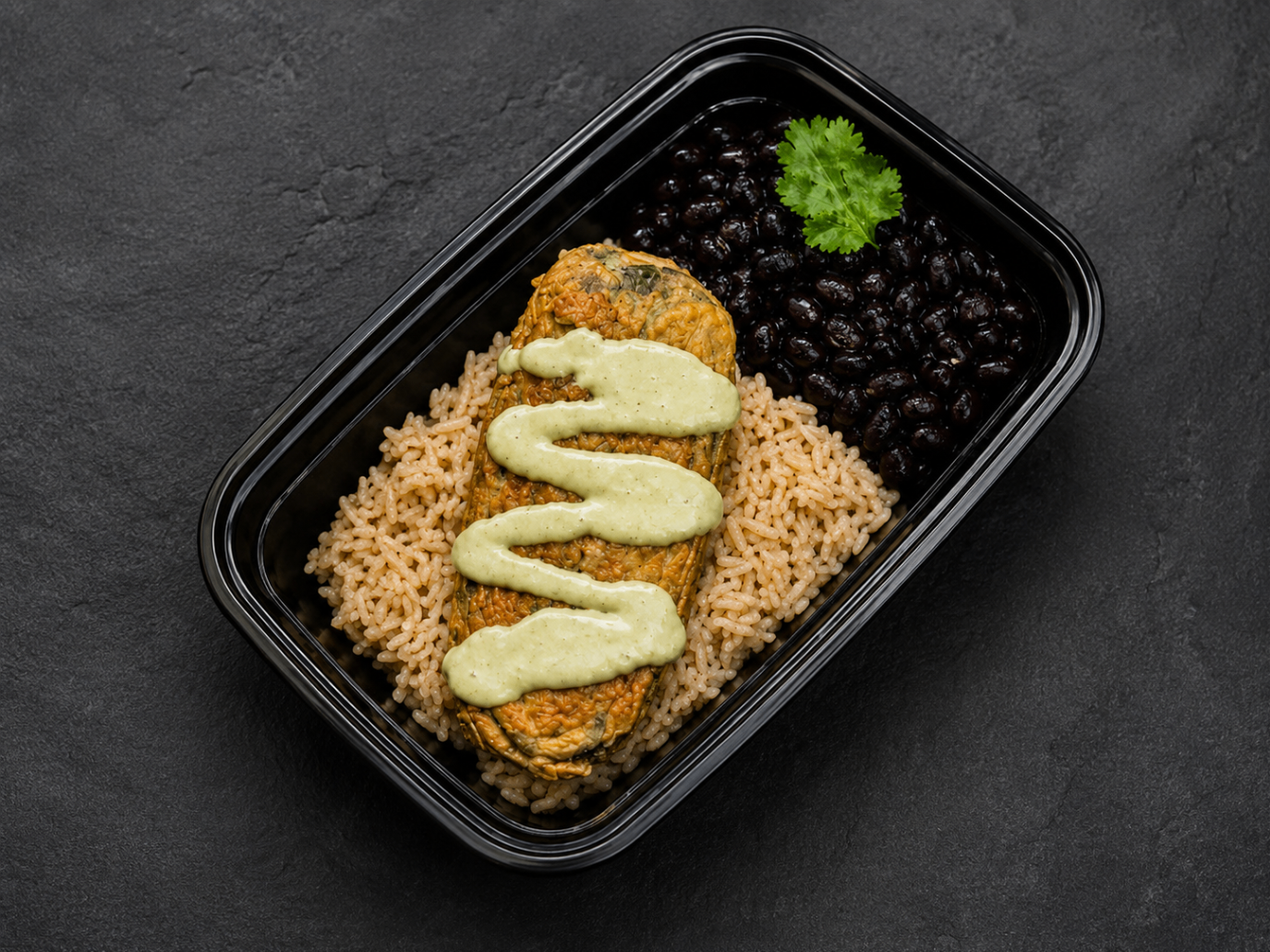 Chile relleno meal prep with cheese-stuffed pepper, green sauce, rice and black beans